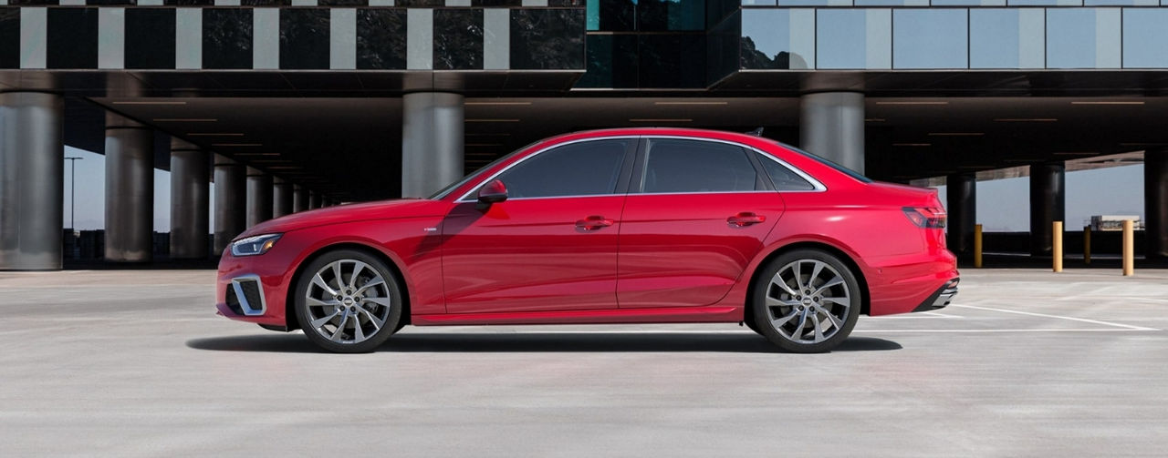 A red 2020 Audi A4 in front of a a building.
